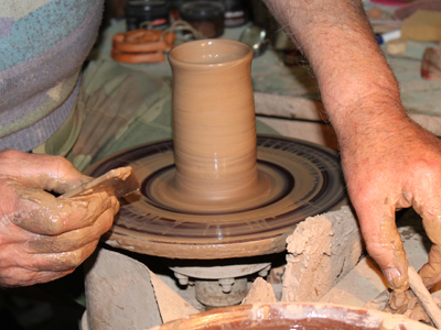 A potter at the wheel in Dudutki Museum